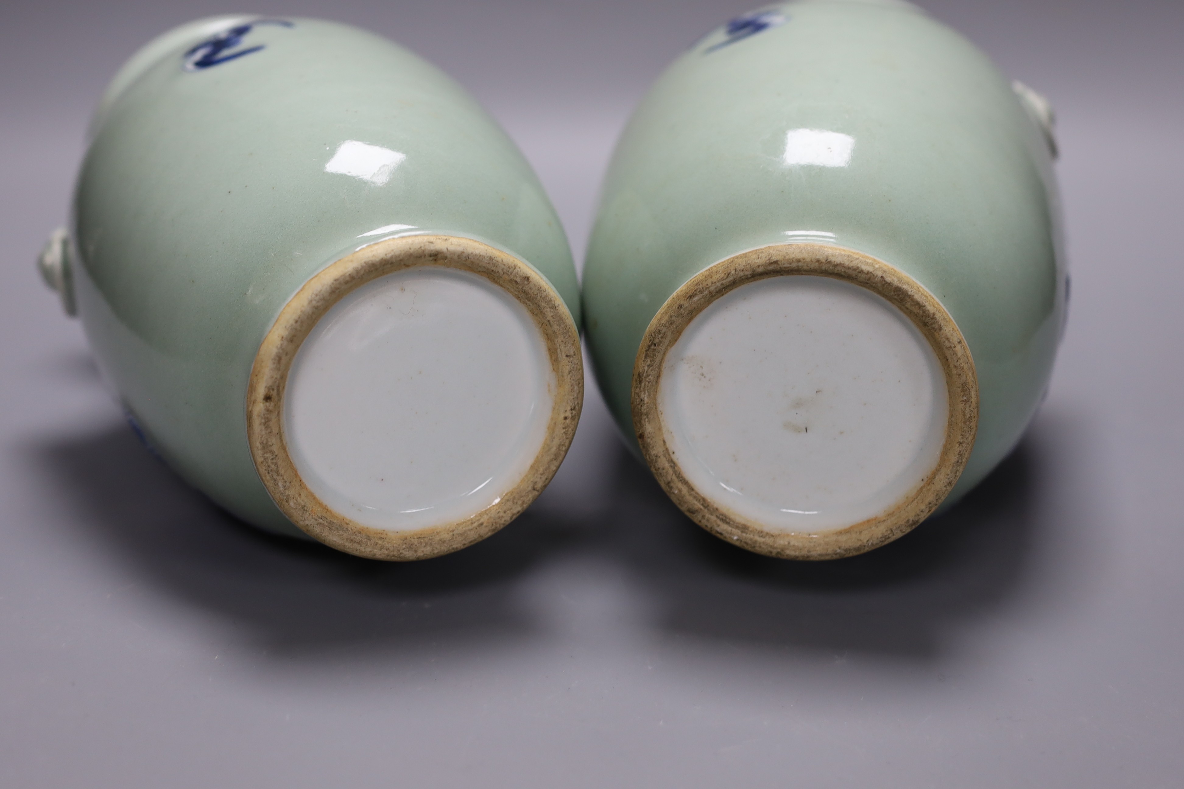 A pair of Chinese blue and white celadon ground vases, 26cms, painted with figures